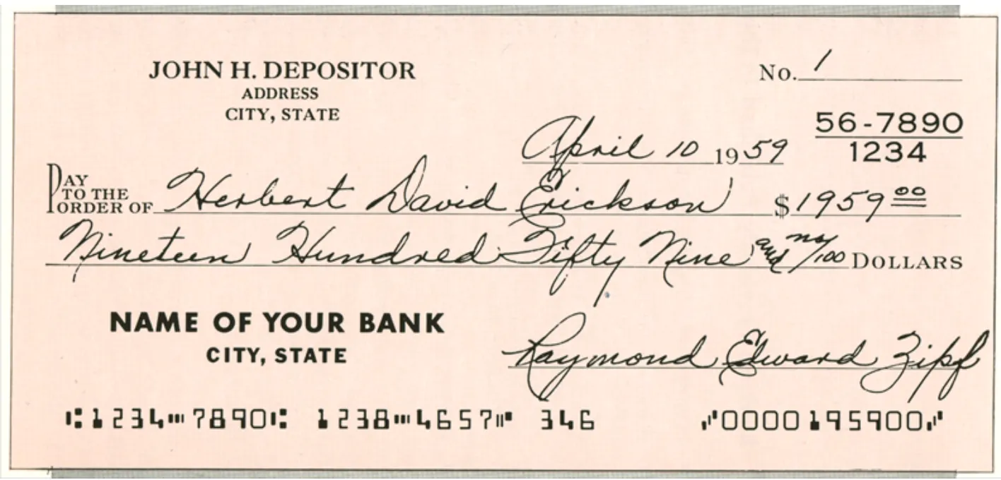 1959年4月10日付の見本の小切手。振出人は JOHN H. DEPOSITOR、金額は1959ドル。下端に E-13B の数字と記号で MICR ラインが印字されている