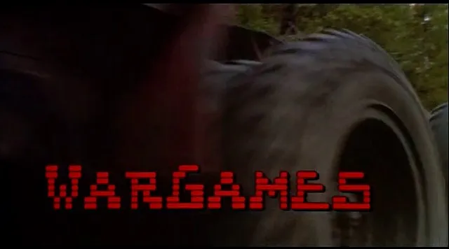 森の道を走るトラックの映像に、赤いドットの文字で「WARGAMES」